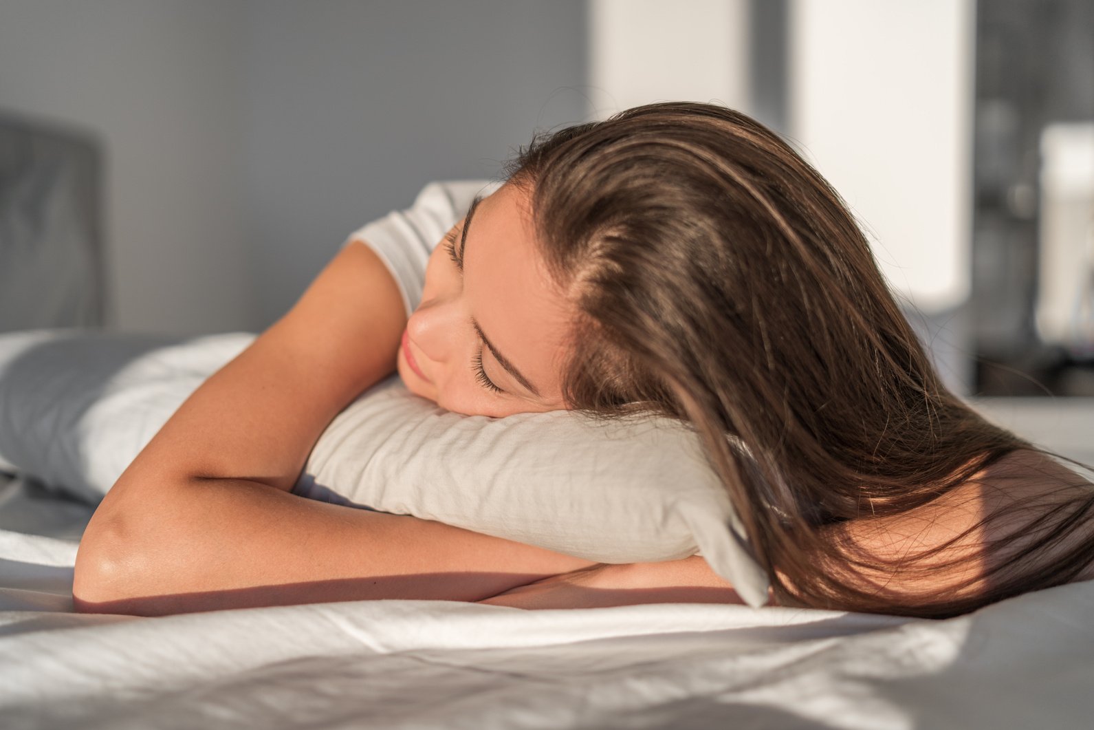 Sleeping on Foam Pillow Bed Asian Girl Sleeping on Stomach Sleeper Resting Head on Foam Pillow. Hair Care Silk Pillowcase. Good Night Sleep or Midday Nap