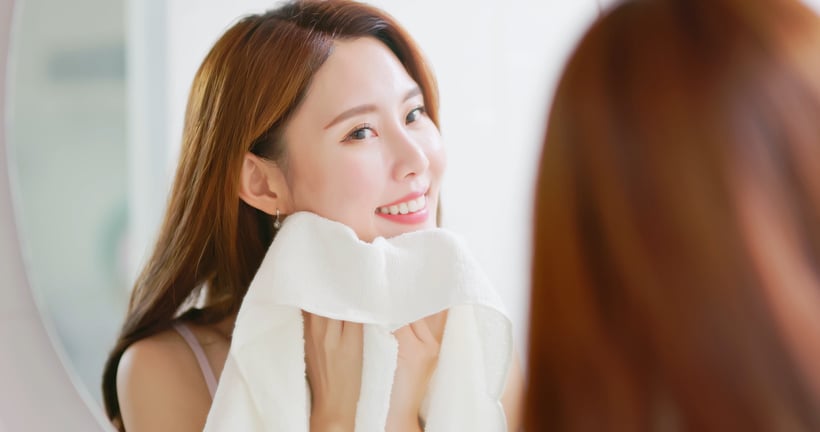 woman clean face by towel