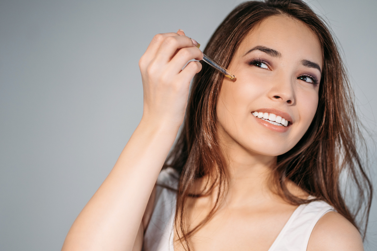 Woman Applying Serum on Face